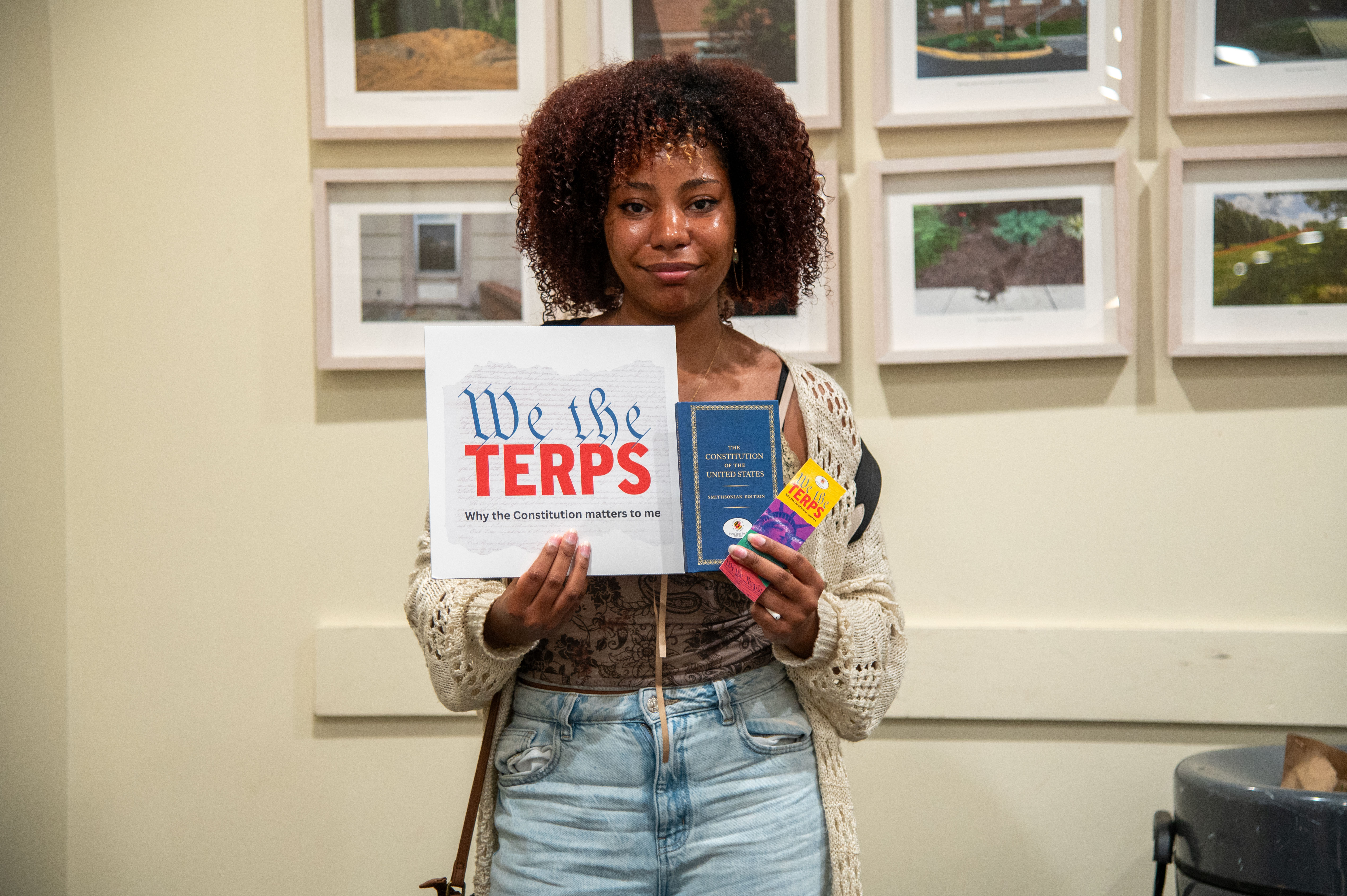 student holding constitution and sign